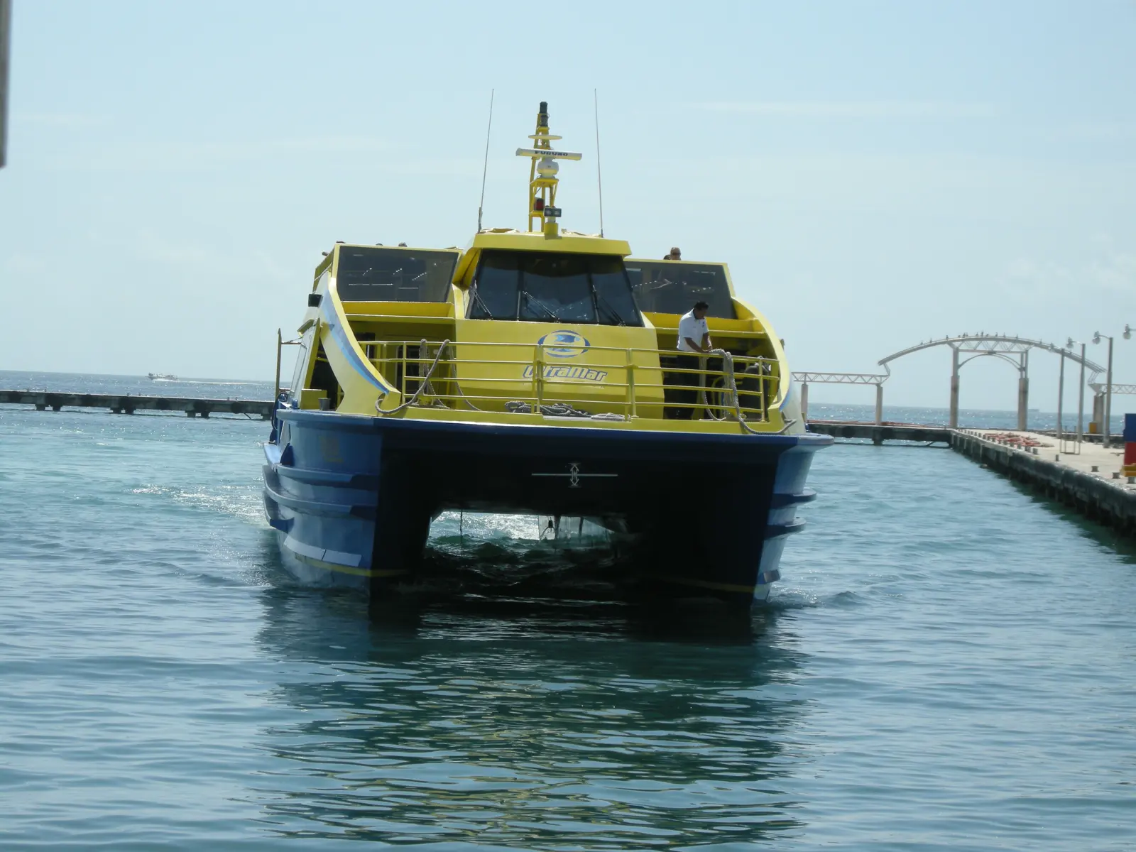A blue and white ferry with Isla Mujeres written on it